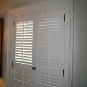 Exterior louvered shutters with classic architectural detailing