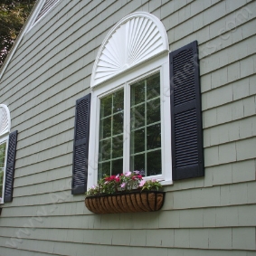 Ornate window with decorative trim and detailed moulding