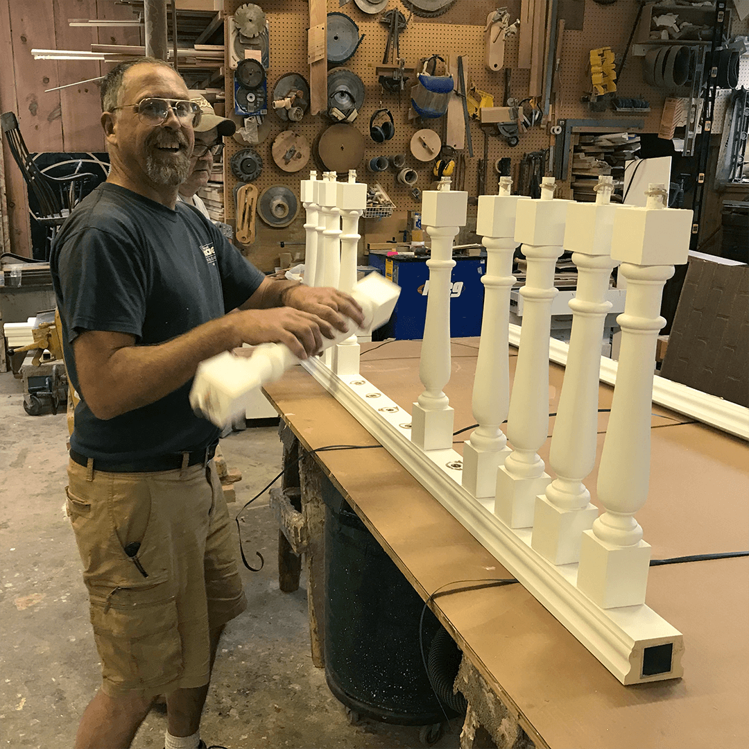 custom millwork supply - Carpenters Pete and Glen assembling a section of polyurethane railing. The railing is primed white and is ready to paint. It will never rot and, once painted, look just like wood.