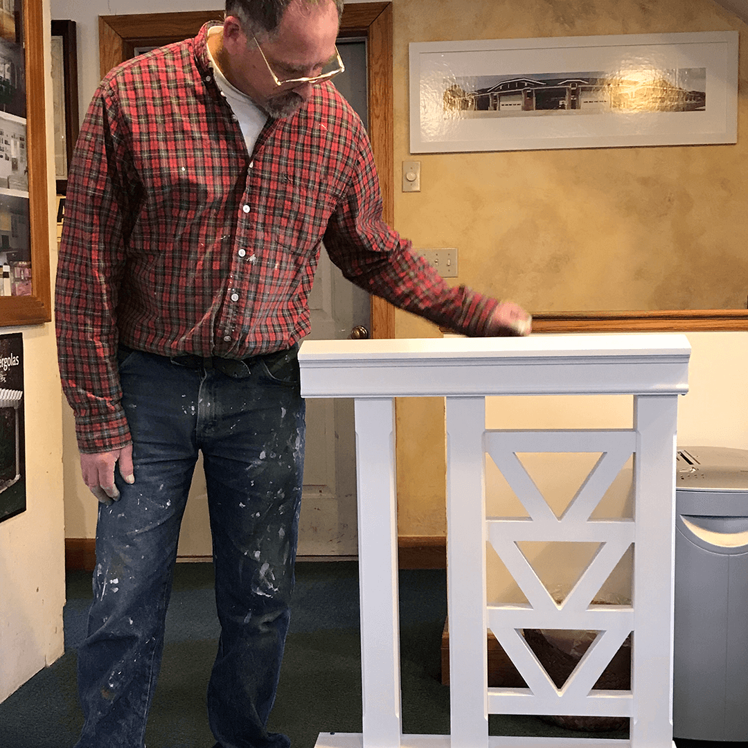 Man standing next to a decorative railing system